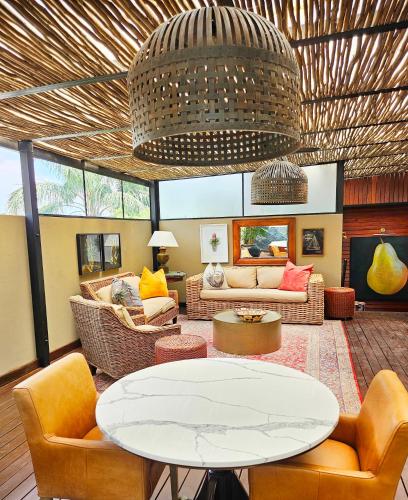 a living room with a table and chairs at The Residence in Johannesburg
