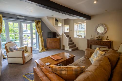 a living room with a couch and a table at Harmony House Boutique B&B in Stillingfleet