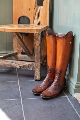a pair of brown boots sitting next to a table at Harmony House Boutique B&B in Stillingfleet
