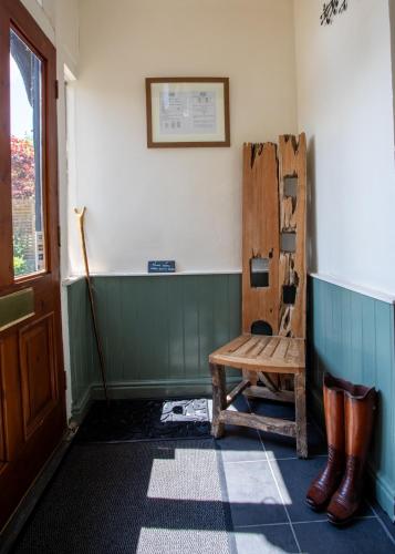 a room with a wooden bench and a broom at Harmony House Boutique B&B in Stillingfleet