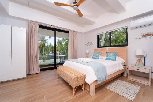 a bedroom with a bed and a large window at Villa Mery - El Portillo Near The Beach in El Limón