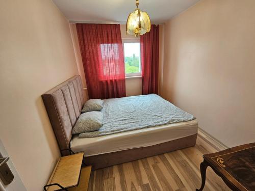 a small bedroom with a bed and a window at First Green Żoliborz Apartment 9 in Warsaw