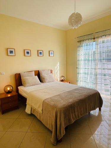 a bedroom with a large bed and a window at by blen.d in Albufeira