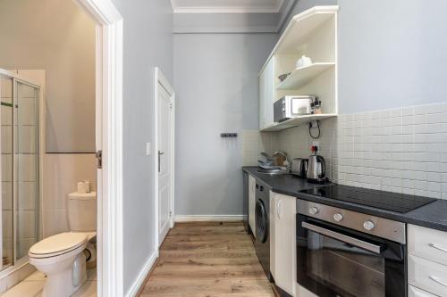 a small kitchen with a toilet and a sink at Long Street Boutique Hotel in Cape Town