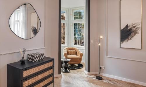 a living room with a chair and a mirror at River Dance Suites by Adrez in Prague
