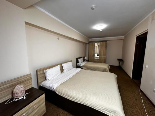 a hotel room with two beds in a room at Санаторий Казахстан in Gornyy Gigant