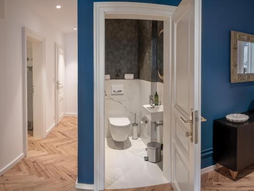 a bathroom with a toilet and a sink at River Dance Suites by Adrez in Prague