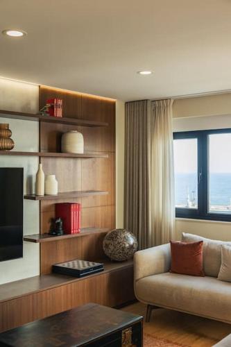 a living room with a couch and a television at Ocean Vista - Premium CityCenter in Ponta Delgada