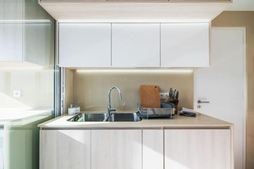 a kitchen with white cabinets and a sink at Ocean Vista - Premium CityCenter in Ponta Delgada