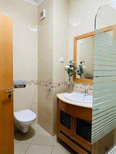 a bathroom with a sink and a toilet and a mirror at by blen.d in Albufeira