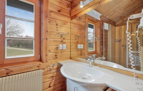 a bathroom with a white sink and a window at Ferienhaus Donau 73 in Hayingen