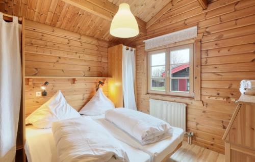 a bedroom with a bed in a wooden room at Ferienhaus Donau 73 in Hayingen
