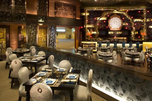 a restaurant with tables and chairs and a bar at The Venetian Macao in Macau