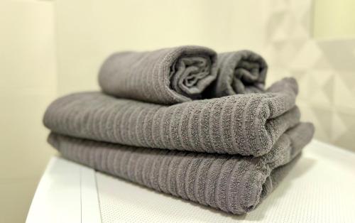 a stack of towels sitting on a counter in a bathroom at K22 Komputerowa 7 Chopin Airport in Warsaw