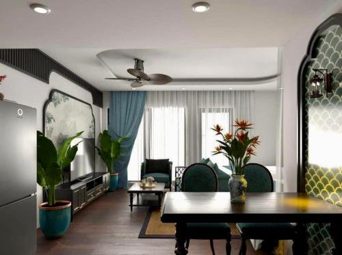 a living room with a table and some plants at FLC Sea Tower Wins Quy Nhơn in Quy Nhon