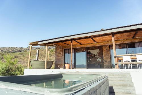 a swimming pool in front of a house at Wolfkop Nature Reserve in Citrusdal