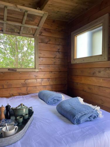 a bedroom with a bed in a log cabin at Luxury Experience in Off The Grid Lodge at an Amazing Lake Vinkeveense Plassen in Vinkeveen
