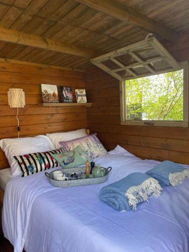 a bed in a cabin with a tray on it at Luxury Experience in Off The Grid Lodge at an Amazing Lake Vinkeveense Plassen in Vinkeveen