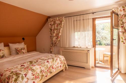 a bedroom with a bed and a large window at Vila Crisalia Sibiel -Sibiu in Sibiel