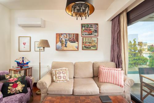 a living room with a couch and a chandelier at Luxury City One-bedroom Apartment in Heraklio