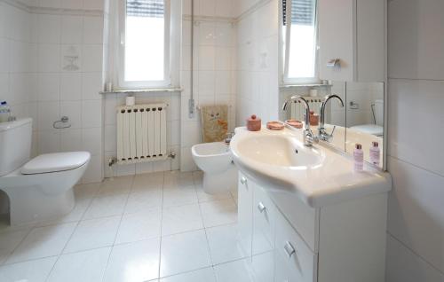 a white bathroom with a sink and a toilet at Gorgeous Apartment In Corsanico With House A Panoramic View in Corsanico-Bargecchia