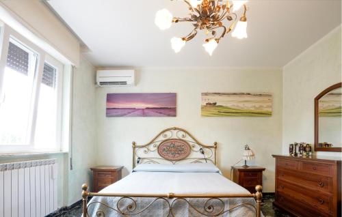 a bedroom with a bed and a chandelier at Gorgeous Apartment In Corsanico With House A Panoramic View in Corsanico-Bargecchia