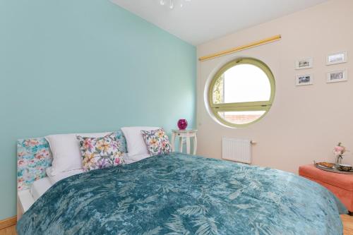 a bedroom with a bed and a round window at Seaside Apartment with Parking in Sopot by Renters in Sopot