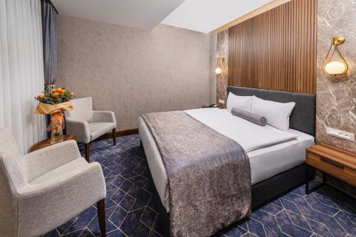 a hotel room with a bed and two chairs at Ring Stone Hotels Bosphorus - Special Class in Istanbul