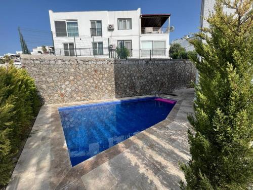 a villa with a swimming pool in front of a house at No 444 in Dalaman