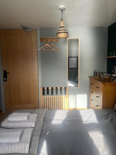 a bedroom with a bed with two pillows and a mirror at Stein Inn in Stein
