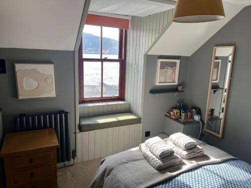 a bedroom with a bed with towels on it at Stein Inn in Stein