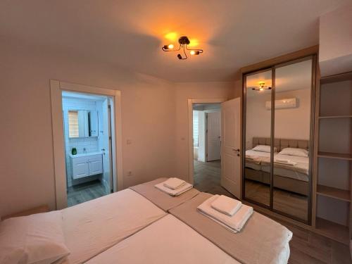 a bedroom with a large bed and a mirror at No 444 in Dalaman