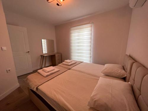 a bedroom with a large bed with two towels on it at incebel No 444 in Dalaman
