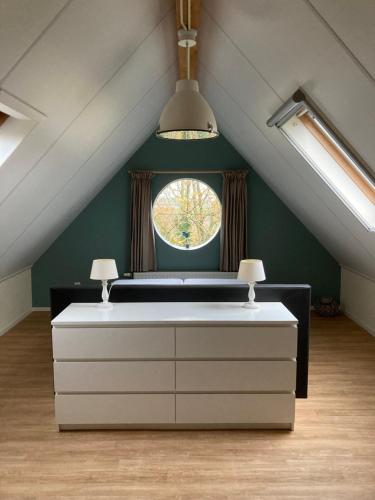 a room with a window in a attic at 't Uilengat 6-8 persoons appartement in Retranchement