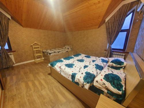 a bedroom with a bed and a wooden ceiling at Luxury Forestside Villa in Quba