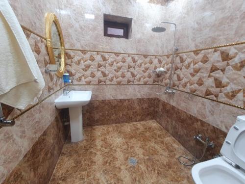 a bathroom with a toilet and a sink and a shower at Luxury Forestside Villa in Quba