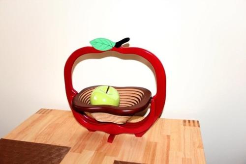 a red apple chair with an apple in a basket at Am Apfelbaum 4 Pers in Röbel