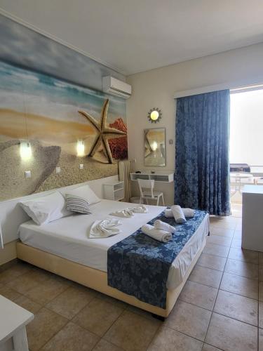 a bedroom with a large bed and a large window at ASTIR COSY LIVING HOTEL in Áyios Konstandínos