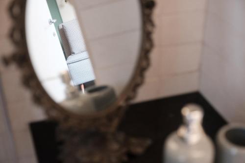 a toothbrush in front of a mirror in a bathroom at Casa Catalé in Modica