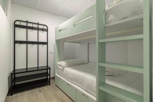 a room with two bunk beds and a small bed at Allo Apartments Arroyo Catedral in Jerez de la Frontera