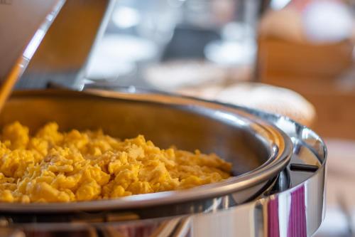 a metal pan filled with food in a stove at Hotel Il Portico by LVG Hotel Collection in Cannobio