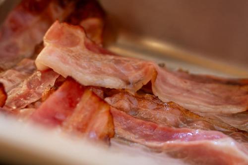 a pile of bacon sitting on top of a plate at Hotel Il Portico by LVG Hotel Collection in Cannobio