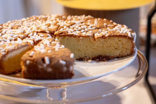 a cake on a glass plate on a glass plate at Hotel Il Portico by LVG Hotel Collection in Cannobio
