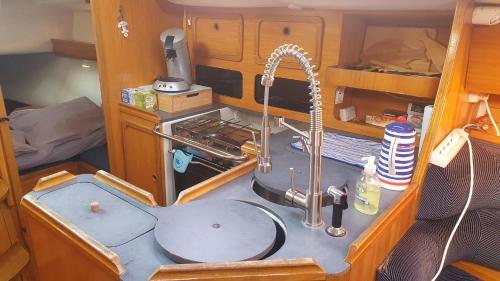 a kitchen counter with a sink and a sink at Nuits au Port - vieux port - "Super Castor" voilier à quai in La Rochelle