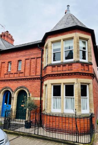 a red brick building with a large window at Luxury City Centre Townhouse - Sleeps 6 in Chester
