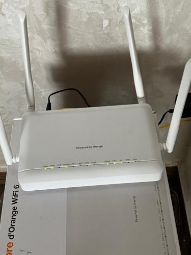 a white router sitting on top of a box at Appartement Dar Bouazza Tamaris Casablanca Airport AquaParc Fibre Orange Wifi Parking Security in Dar Bouazza
