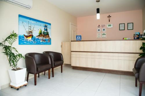 a waiting room at a hospital with chairs and a counter at Pousada Mar Do Leste in Florianópolis
