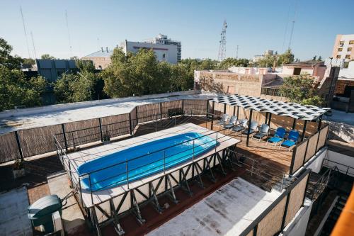 a swimming pool on the roof of a building at Patio Mediterraneo Apart Hotel in San Rafael