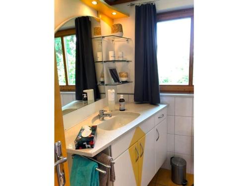 a bathroom with a sink and a window at Beautiful holiday home near town centre in Reisach