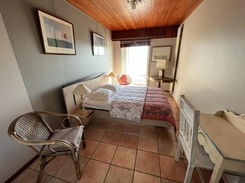 une chambre avec un lit, une table et une chaise dans l'établissement Bel Appartement 2 Chambres avec Accès Direct Plage à Saint-Gilles-Croix-de-Vie - FR-1-324-547, à Saint-Gilles-Croix-de-Vie